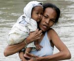 A mother cuddles her child while wading through floodwaters in Taytay township, Rizal province east of Manila, Philippines Friday Oct.2, 2009. (Marquez/AP) 